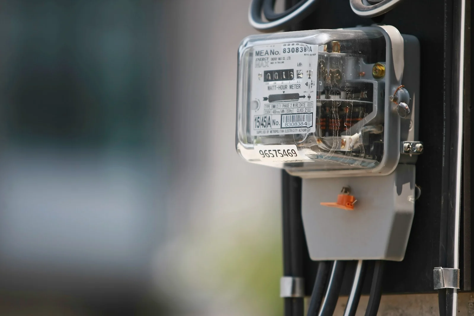 powerbox on the side of a electrical pole on the streen next to a home that is net metering power